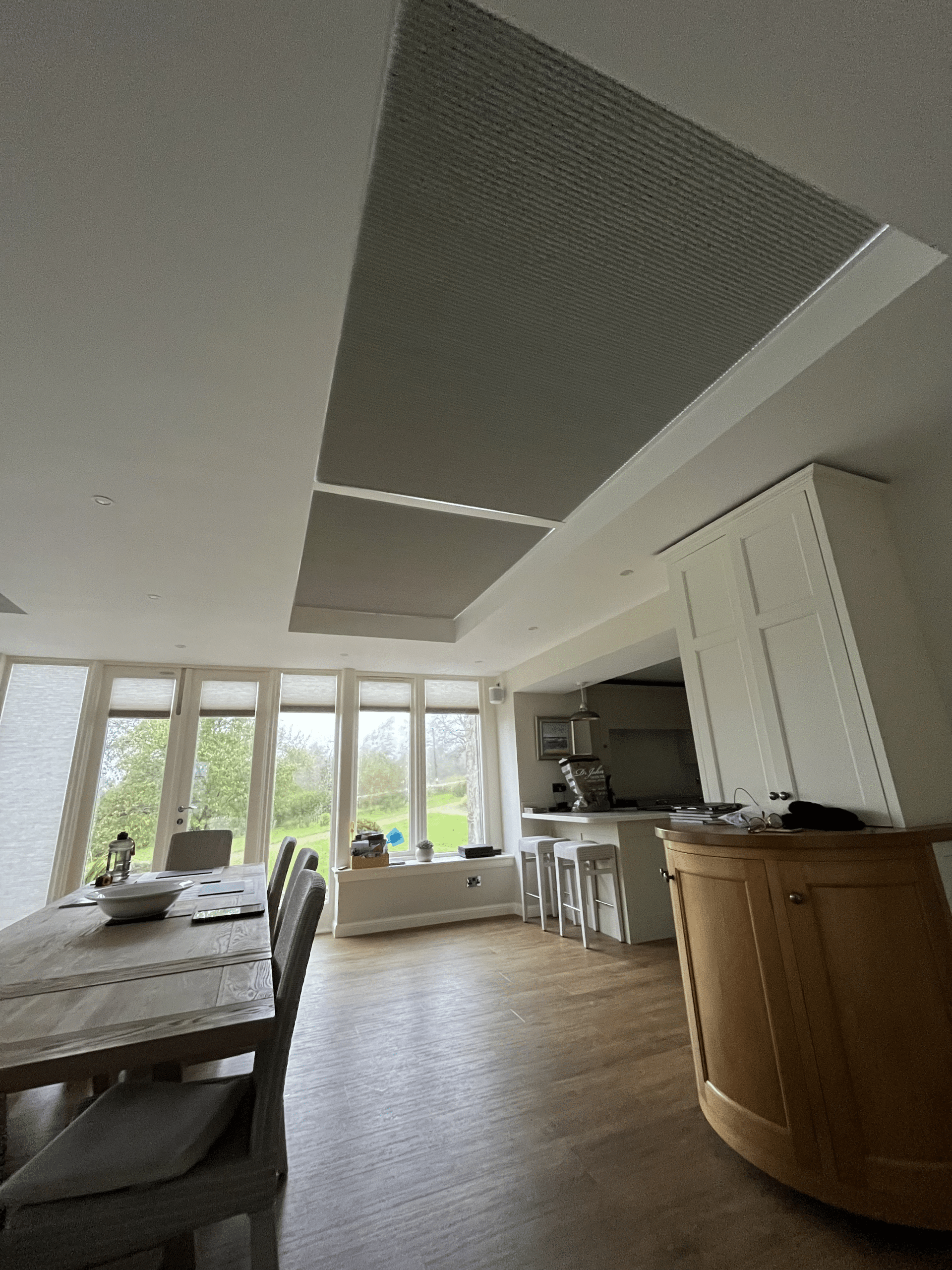 Grey honeycomb Duette blinds fully closed over a roof lantern in a Cupar kitchen to control temperature and glare.