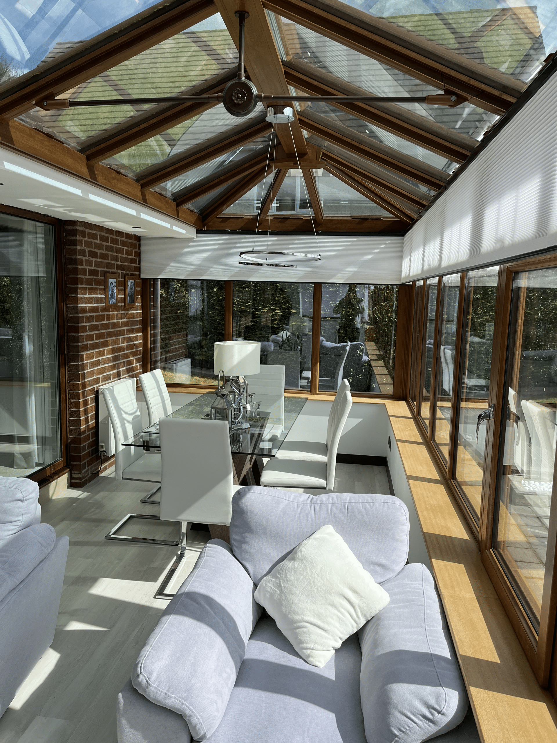 Modern conservatory in Glasgow with electric thermal blinds partially open during sunny weather