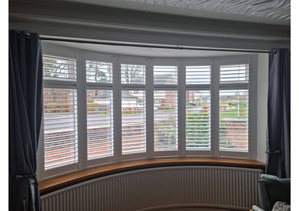 Made-to-measure plantation shutters fitted to a curved bay window in a Glasgow home